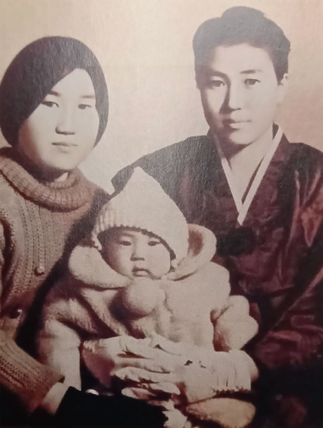 Han Tae-soon (right) cradles her daughter, Kyung-ha, on her 100th day.