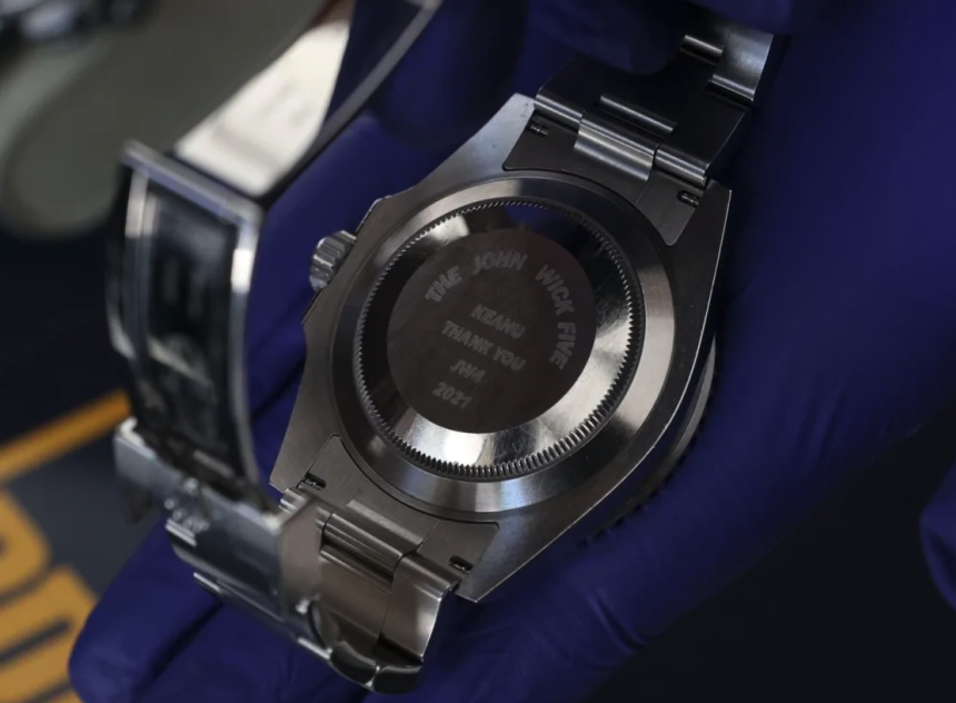 Detail of the seized Rolex watch, with Keanu Reeves' name and a reference to the film John Wick.