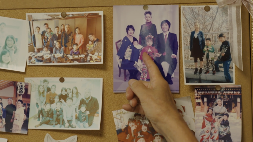 Morioka points to a photograph of his family at his home, including his wife, who died several years ago.