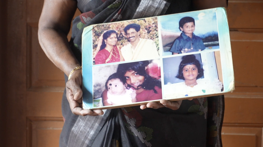 Sivapatham Elangkothai holds photos of her daughter, son-in-law, and three grandchildren who all went missing in 2009.