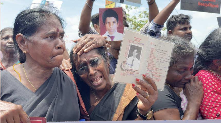 Mary Ranjini Nirmalanathan attends a protest holding an ID card of her son who went missing in 2009, in Jaffna on August 30, 2025.