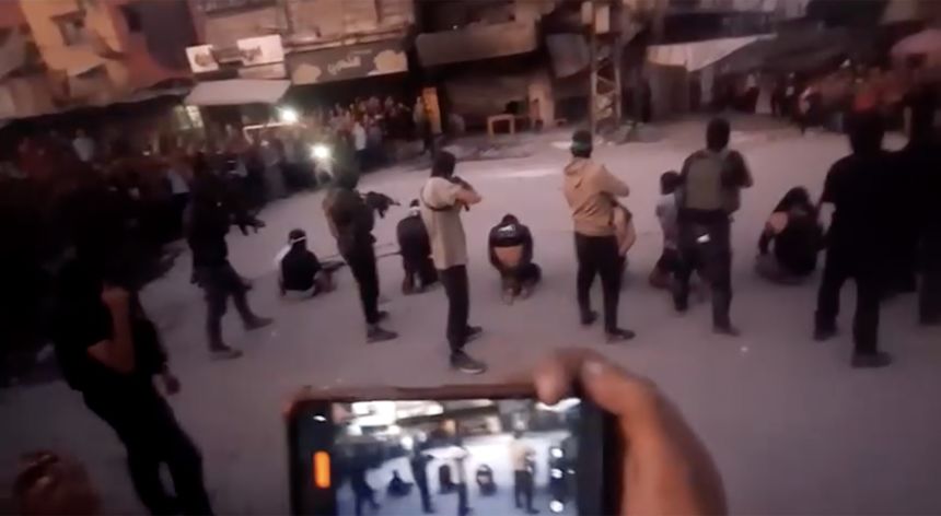 Video shows Hamas armed men dragging seven men into a circle of people in Gaza City, forcing them to their knees and executing them.