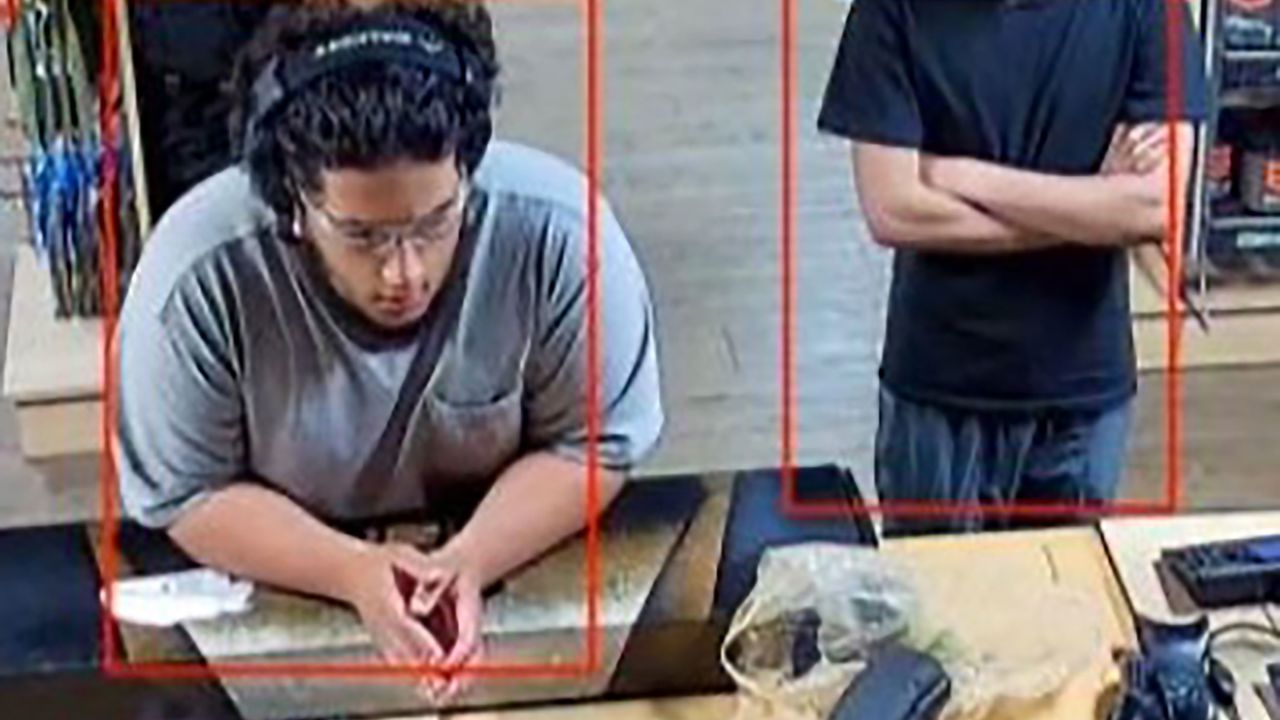 Mohmed Ali, left, and a co-conspirator are seen at a gun store on September 25, according to a criminal complaint. Part of this image has been obscured by the source.