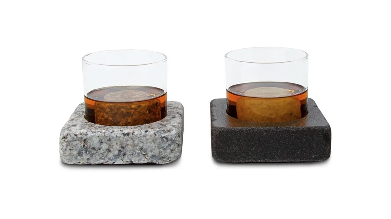 A pair of Sea Stones Cool Coasters with glasses of whiskey inside on a white background.