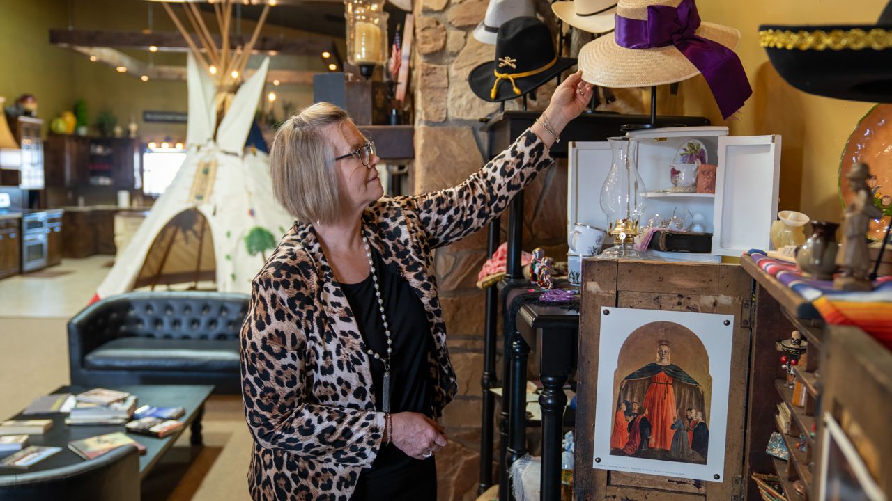 Tina Siemens, who runs the West Texas Living Heritage Museum, showcases traditional Mennonite hats.