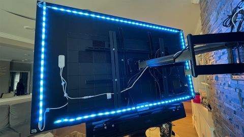 View of the back of a wall-mounted TV, showing that the Sengled LED strips come in precut lengths that make it easy to mount them on the back of a television or monitor without waste. 