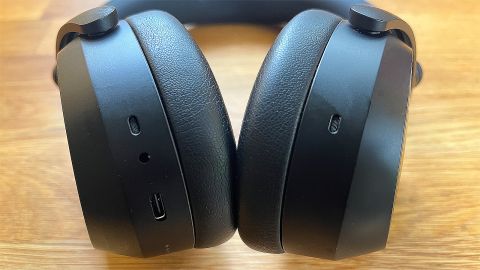 A shot of the lower surface of the Sennheiser Momentum 4 headphones, showing the connections on the bottom of the earcups.