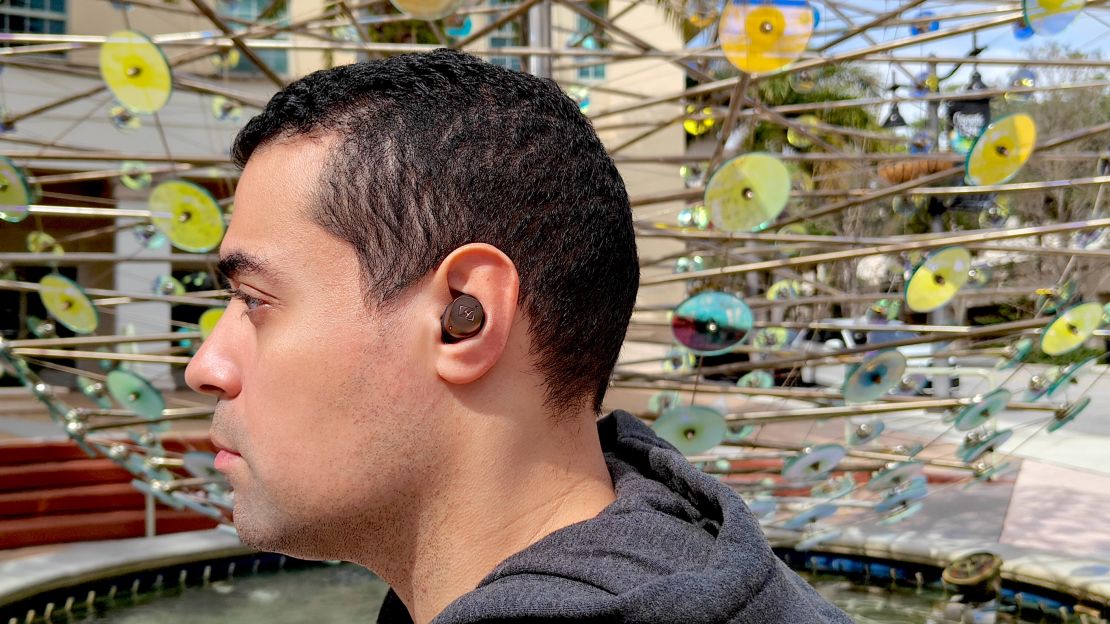 A side profile of CNN Underscored contributor Alex Bracetti wearing the Sennheiser Momentum True Wireless 4 earbuds.