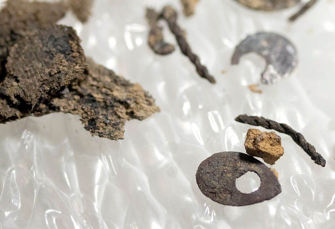 Fabric and sequins uncovered during the excavation of the burials are shown