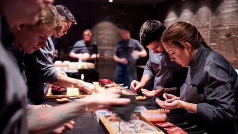 Shot during service at Alchemist. The team at Alchemist plating the impression Tongue Kiss. Head of Pastry Ana Omazic to the left.