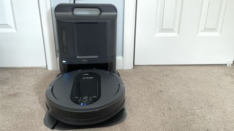 The Shark IQ XL robot vacuum with its base and waste bin