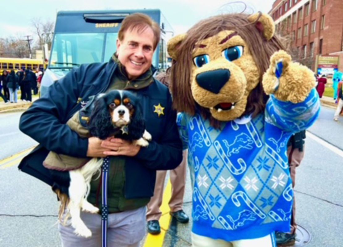 Sheriff Michael Bouchard poses with Max and a costumed mascot.