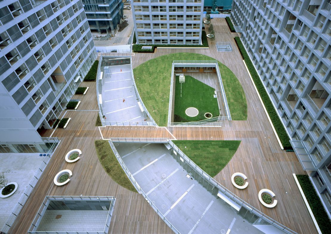 At Shinonome Canal Court in Tokyo, residential blocks are connected by a deck featuring terraces and public green spaces.