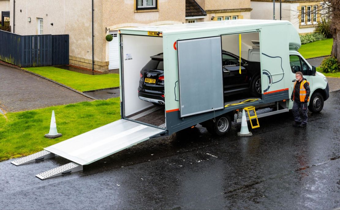 Cars being transported by open carrier