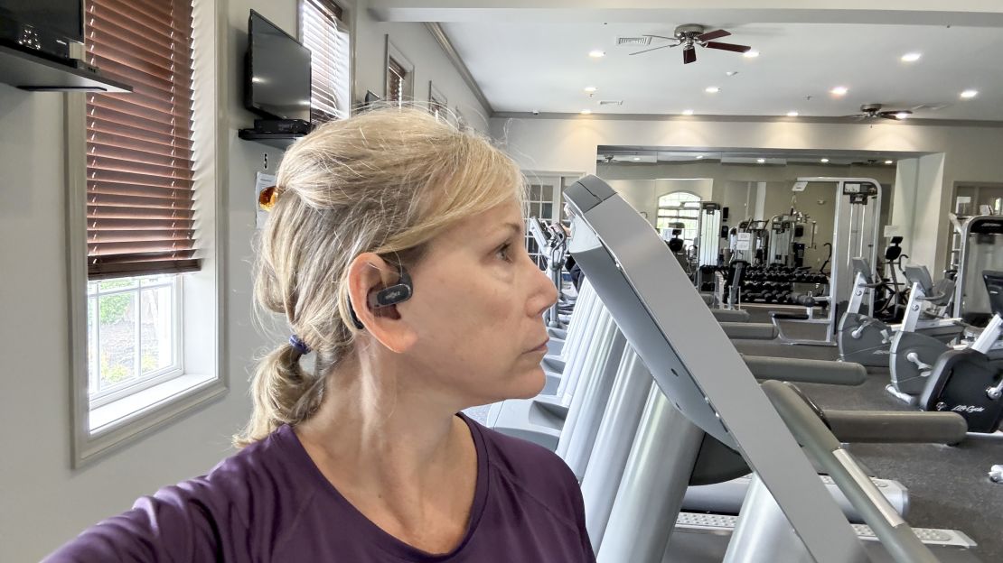 Person wearing Shokz OpenFit Air at the gym.