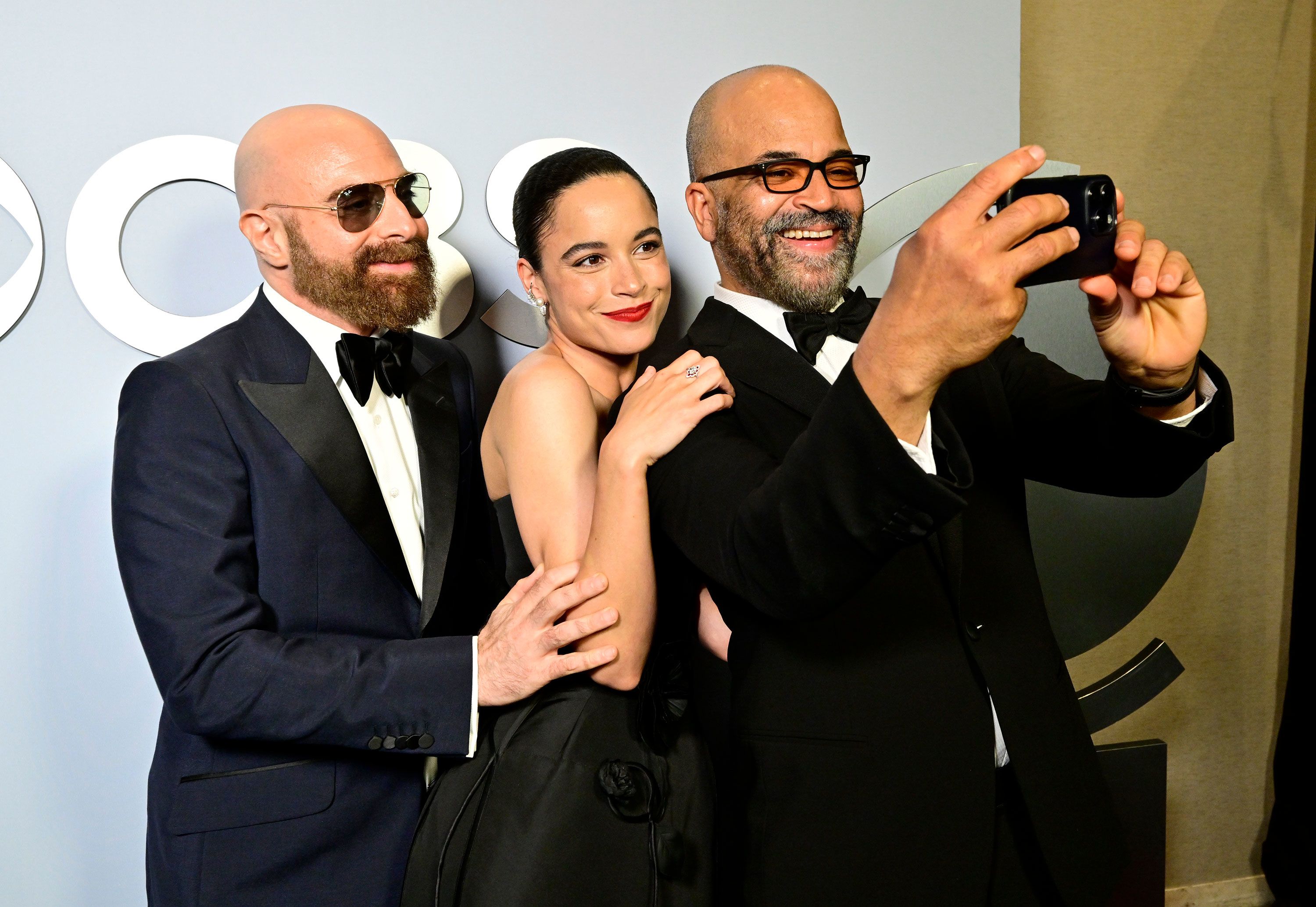 From left, David Adjmi, winner of the best play award for "Stereophonic," Juliana Canfield and Jeffrey Wright take a photo backstage.