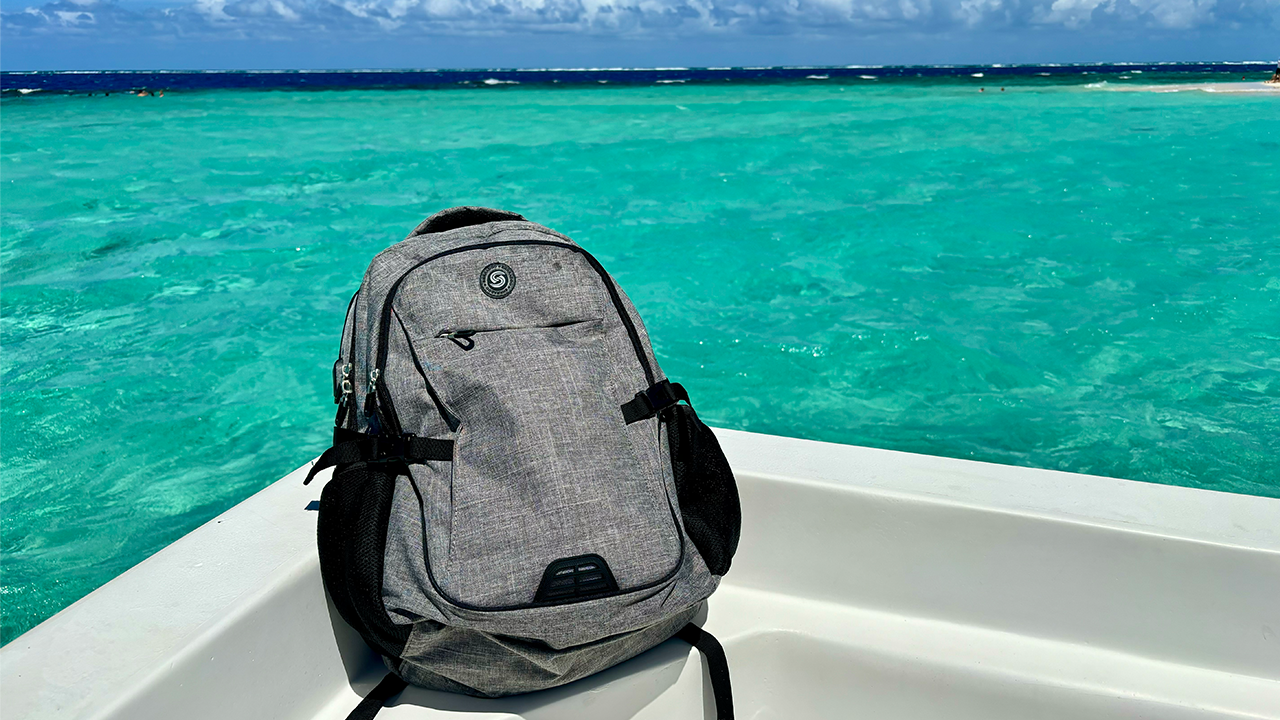 A photo of a SHRRADOO Backpack on a boat with the ocean in the background