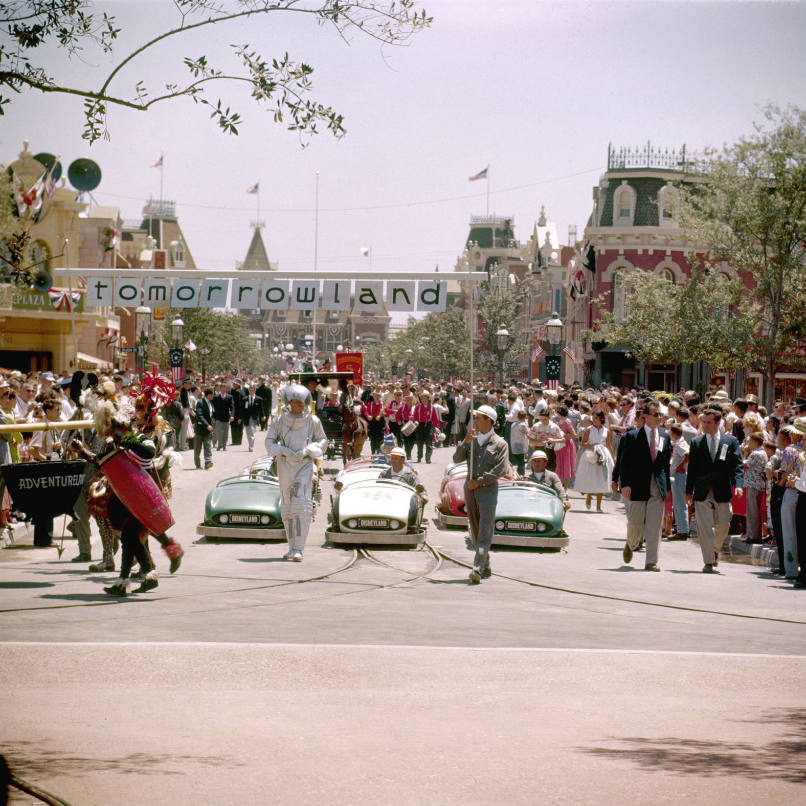 The Tomorrowland portion of the parade marches by the crowd. That part of the park has a futuristic theme.
