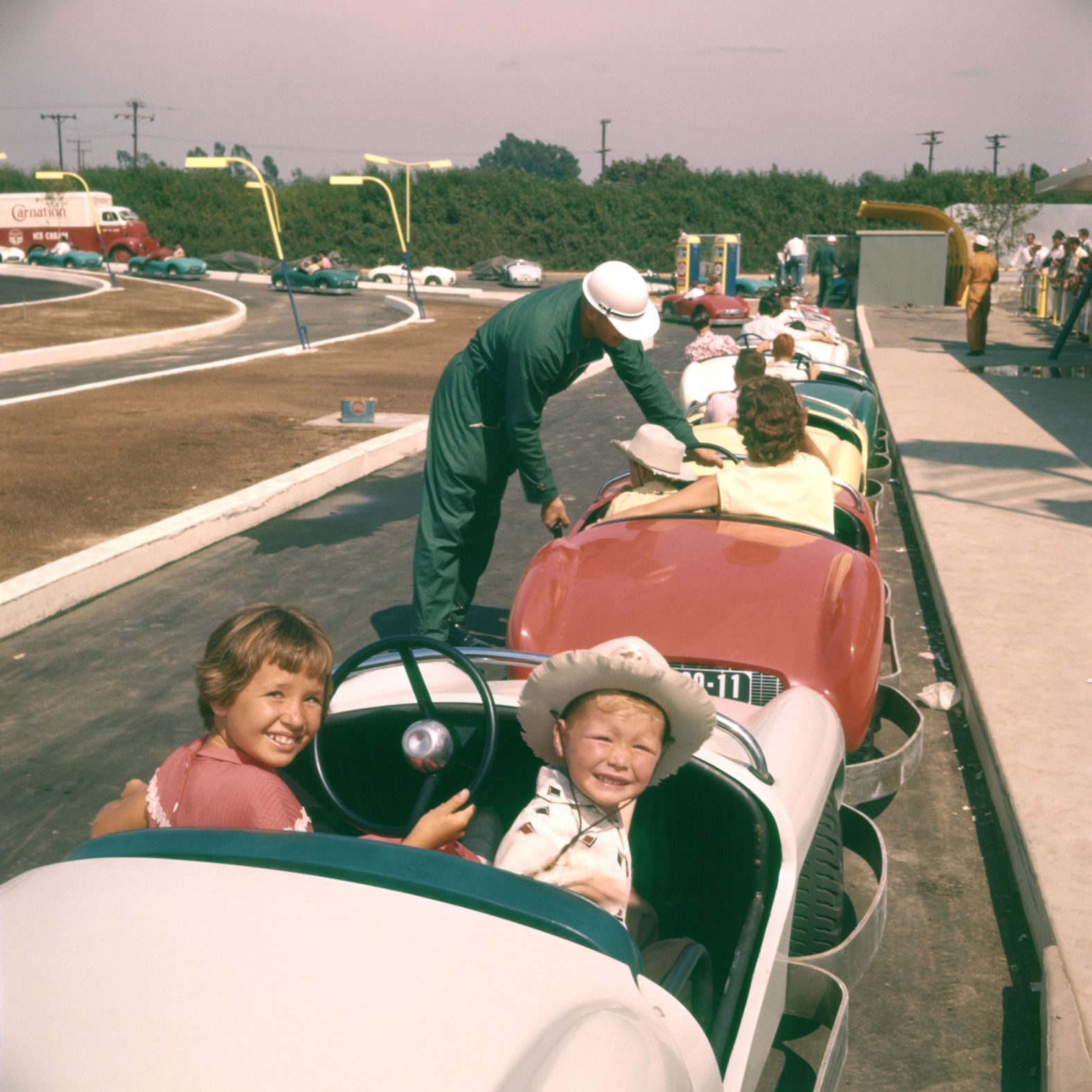 Children pose for a photo before riding the Autopia car ride.