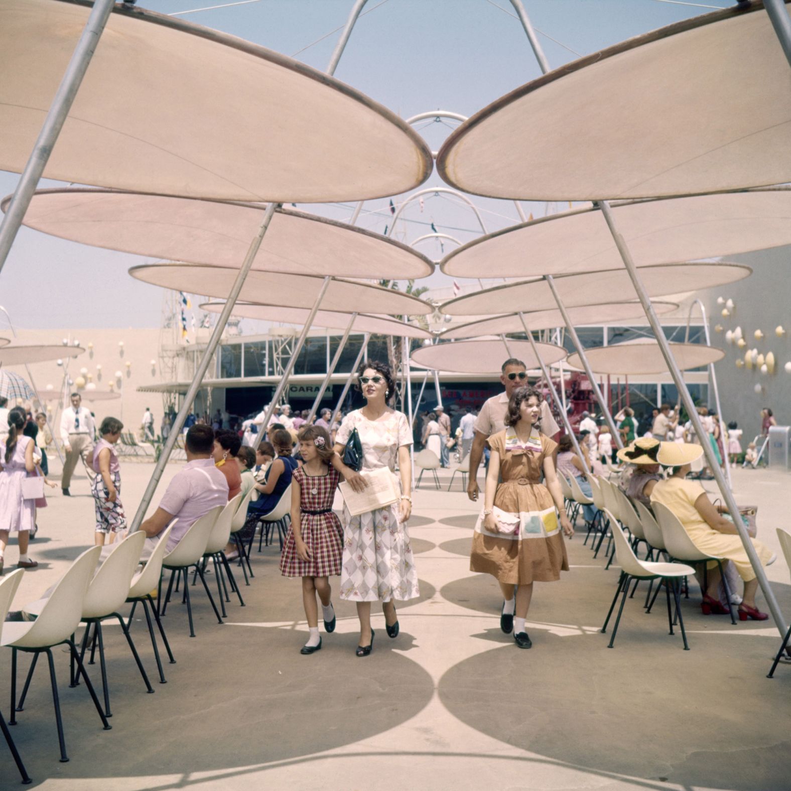 People walk through Tomorrowland's "space port."