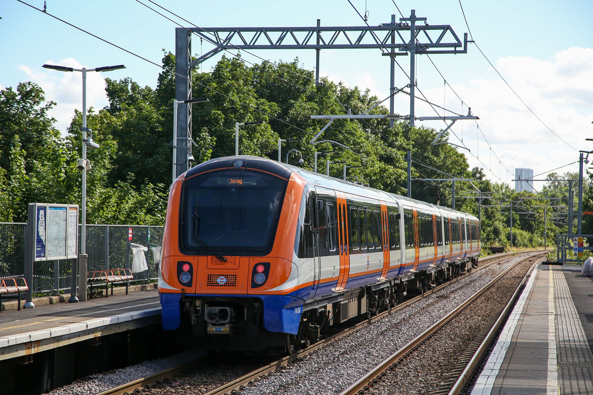 A London Overground train in orange livery.