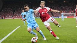 Dante Rossi and Jens Stryger Larsen battle for the ball during a EURO 2024 Qualification game.