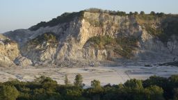 Mandatory Credit: Photo by Mariano Montella/Pacific Press/Shutterstock (14135128c)
Solfatara (Italian: Solfatara di Pozzuoli) is a shallow volcanic crater at Pozzuoli, near Naples, part of the Phlegraean Fields (Italian: Campi Flegrei) volcanic area. It is a dormant volcano, which still emits jets of steam with sulfurous fumes. The name comes from the Latin, Sulpha terra, "land of sulfur", or "sulfur earth". It was formed around 4000 years ago and last erupted in 1198 with what was probably a phreatic eruption - an explosive steam-driven eruption caused when groundwater interacts with magma. The crater floor was a popular tourist attraction until 2017, as it has many fumaroles and mud pools. The area is well known for its bradyseism. The vapors had been used for medical purposes since Roman times. This volcano is where the thermoacidophilic archaeon Sulfolobus solfataricus was first isolated. The archaeon is named for the volcano, as most species of the genus Sulfolobus are named for the area where they are first isolated.
Solfatara di Pozzuoli, Italy - 02 Oct 2023