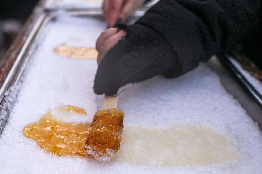 Traditional maple syrup snow taffy is prepared at a winter festival in Alberta.