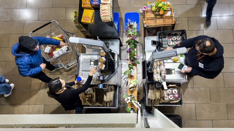 Grocery shoppers use a self-checkout counter at a Whole Foods grocery store in Washington, DC, USA, 14 February 2024.