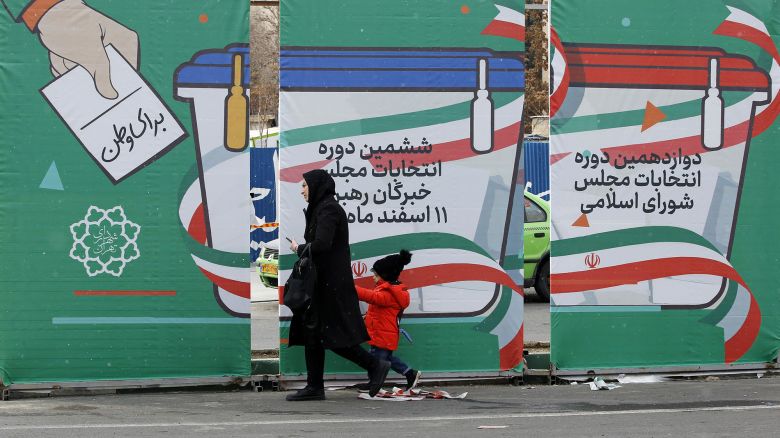 Mandatory Credit: Photo by ABEDIN TAHERKENAREH/EPA-EFE/Shutterstock (14367086a)An Iranian woman with her child walk next to the general election billboard for the upcoming parliamentary elections, in a street in Tehran, Iran, 27 February 2024. Iranians on 01 March 2024 will vote for new members of Iran's parliament, and for the Assembly of Experts, the body in charge of appointing Iran's Supreme Leader.Campaigning for Iran's legislative election, Tehran, Iran Islamic Republic Of - 27 Feb 2024