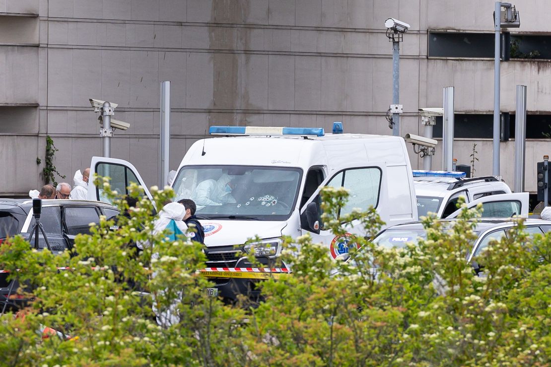 French forensic police inspect a vehicle at Incarville toll station, where gunmen ambushed a prison van.