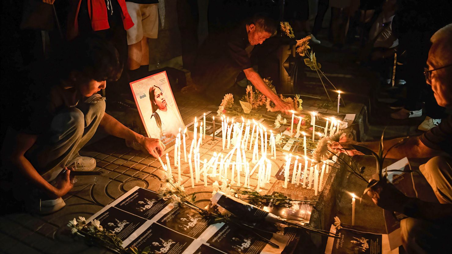 Pro-democracy protesters light candles during a mourning ceremony for activist Netiporn Sanesangkhom outside the Southern Bangkok Criminal Court on May 14, 2024.
