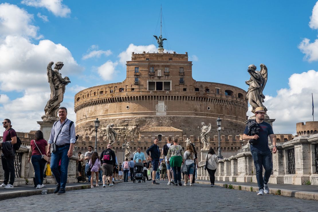 Tourists walk in front of Castel Sant'Angelo in Rome. The high volume of flights to Italy's capital means there are deals to be had for flexible travelers.