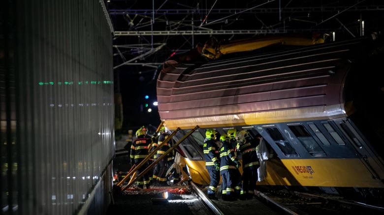 Firefighters work on a derailed wagon after a deadly train crash in the city of Pardubice, Czech Republic on 05 June 2024.