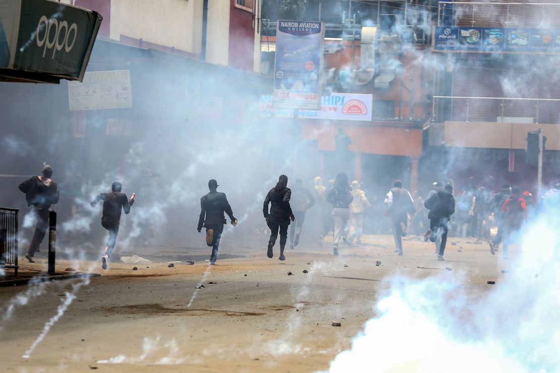 Demonstrators react as police fire teargas to disperse them during a renewed protest on 27 June 2024.