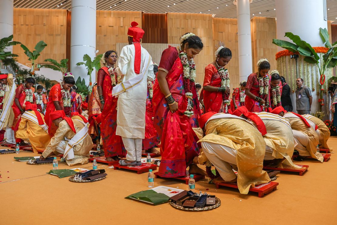 Brides and grooms perform rituals during a mass wedding ceremony for underprivileged couples hosted by Anant Ambani's parents, Nita and Mukesh.