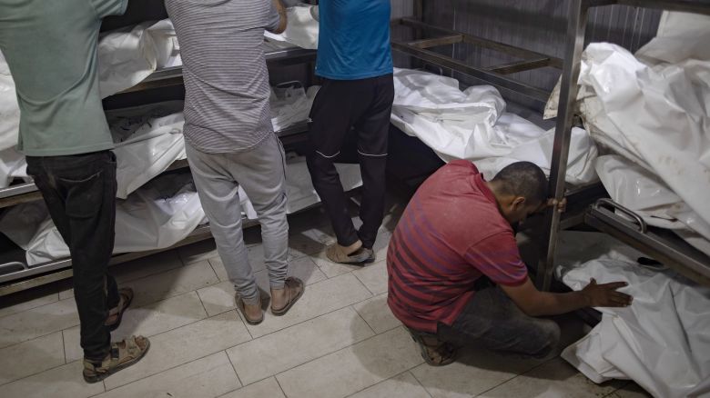 Relatives of killed Palestinians cry next to their bodies inside the morgue at Nasser Hospital in Khan Yunis on July 9, 2024.