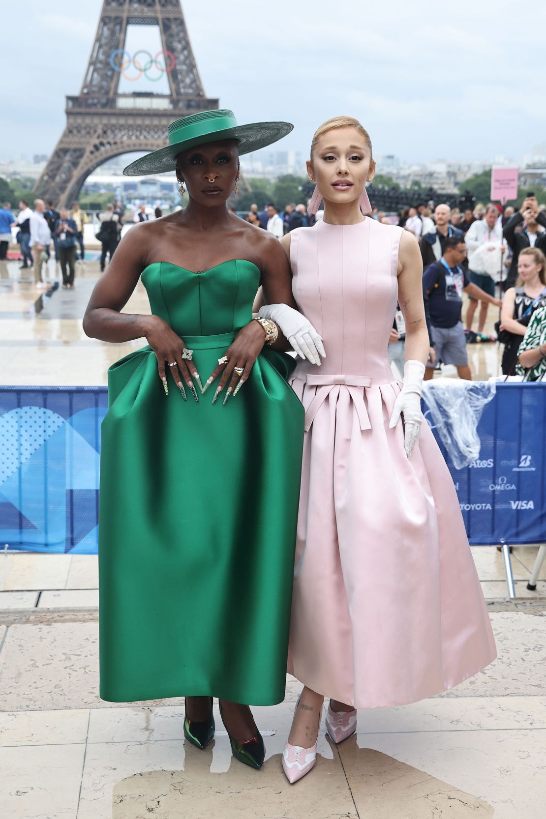 Cynthia Erivo in an emerald green Louis Vuitton gown and Ariana Grande dressed in a pastel pink Thom Browne frock on July 26 in Paris.