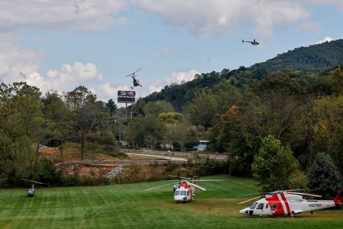 Helicopters use a field in Swannanoa, North Carolina, as a landing zone Thursday to ferry supplies and crews to areas made inaccessible by Helene.