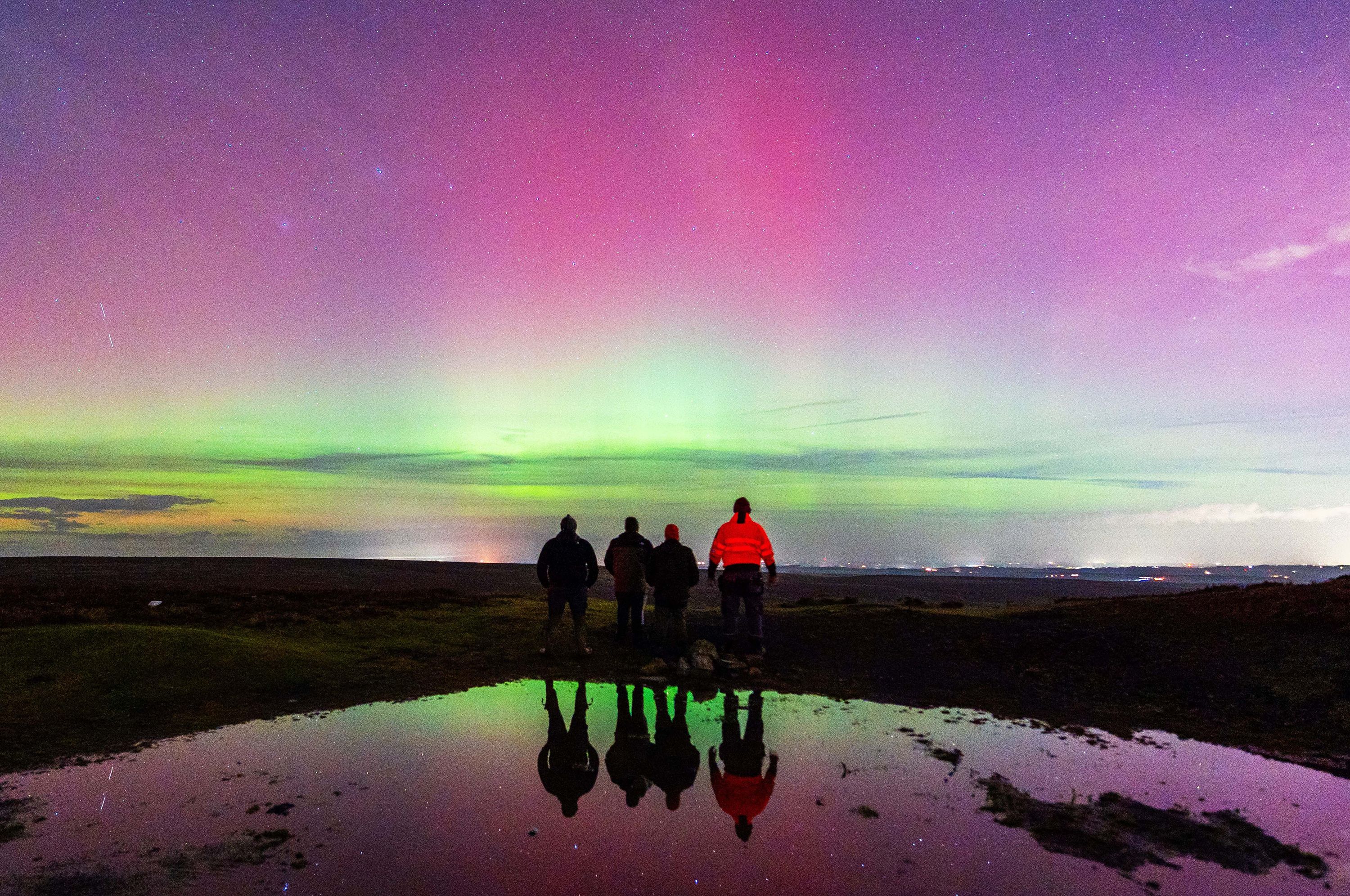 People watch the northern lights in Durham, England on Monday.