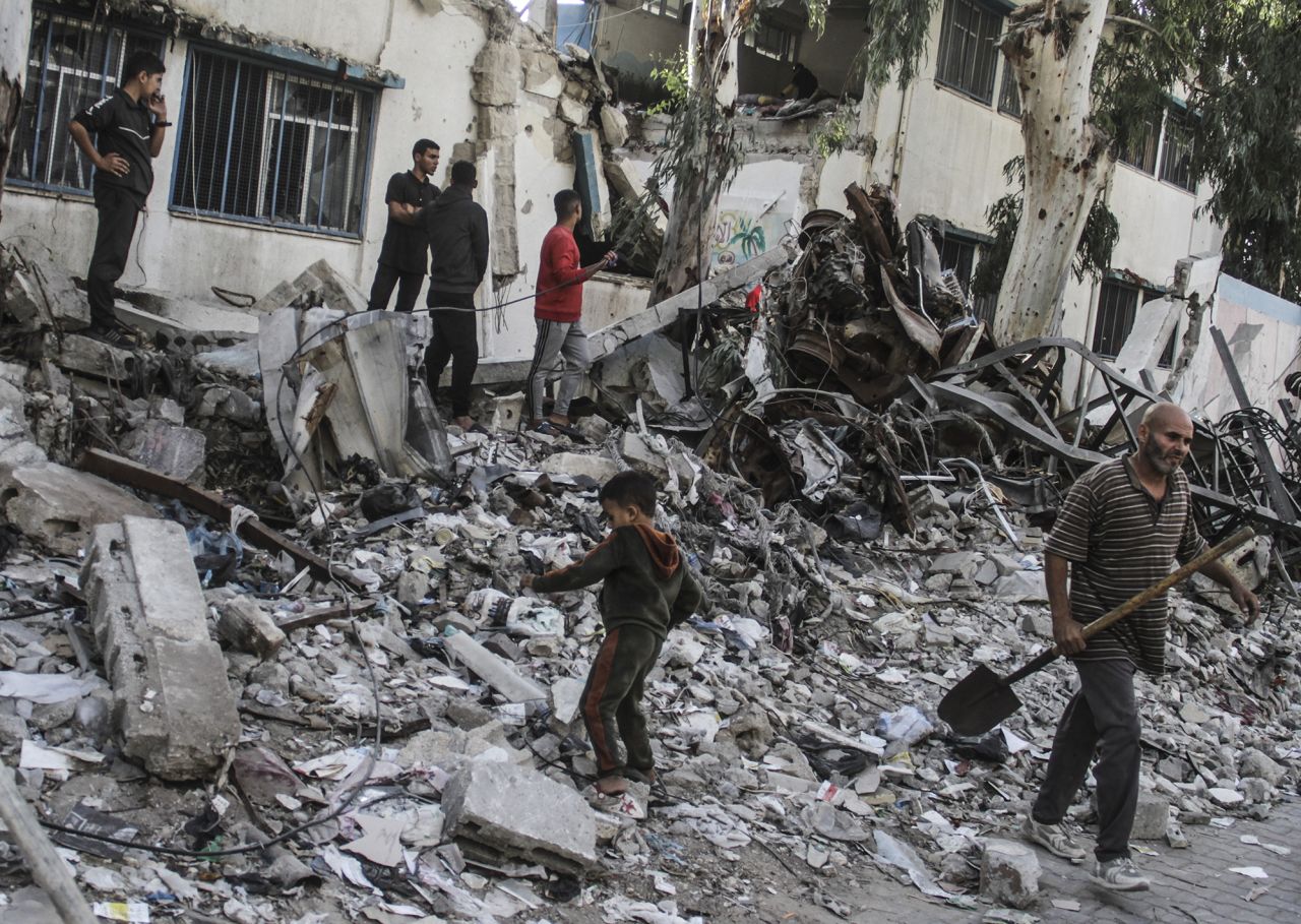 Palestinians inspect their belongings after an Israeli air strike on a school housing displaced Palestinians in the Al-Shati refugee camp in Gaza City on October 27.