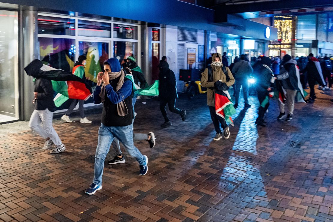 Demonstrators run with Palestinian flags in Amsterdam ahead of the match on Thursday.