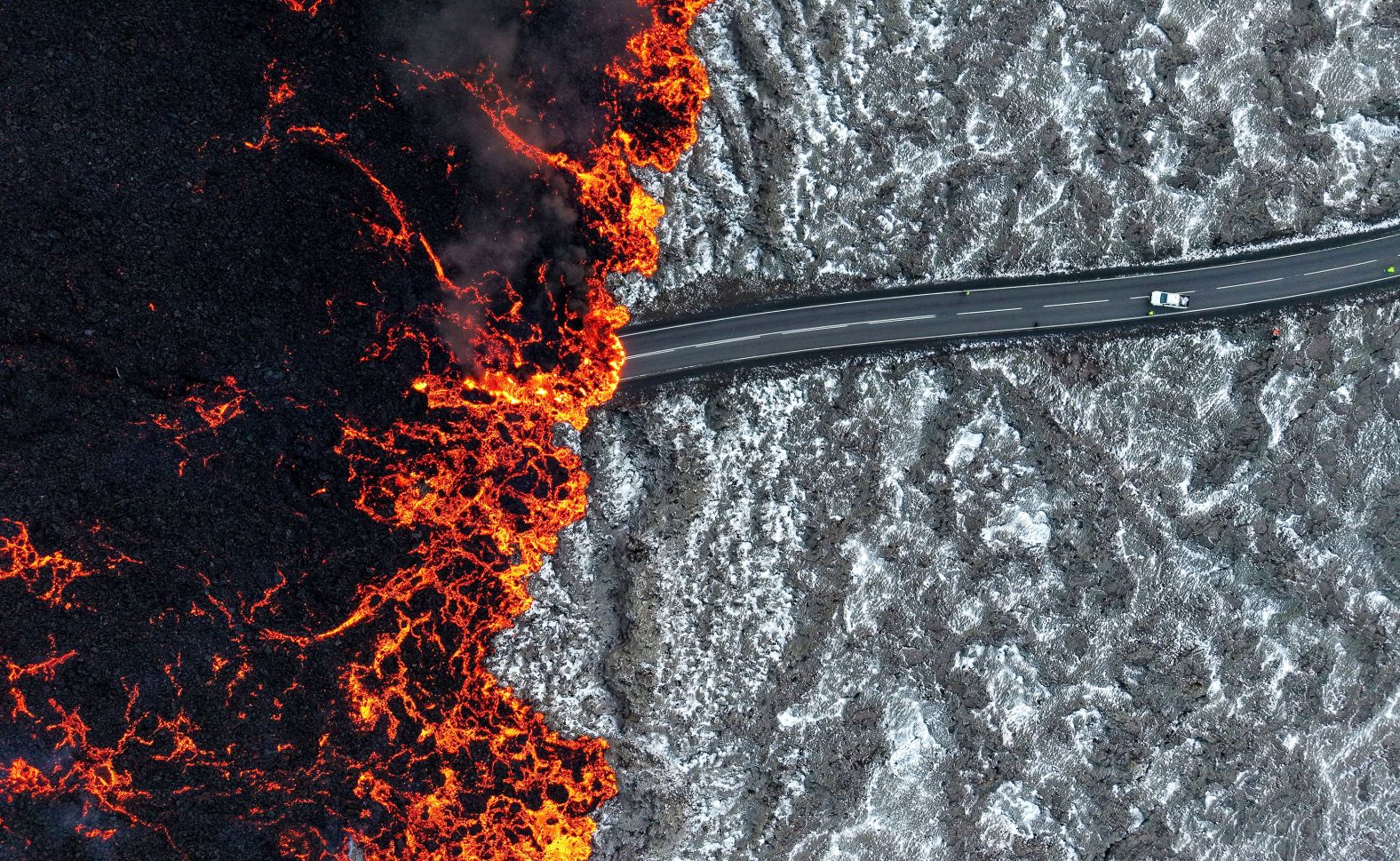 Mandatory Credit: Photo by ANTON BRINK/EPA-EFE/Shutterstock (14933051a) Lava flows across one of the roads near Grindavik, Reykjanes Peninsula, Iceland, 21 November 2024. According to the Icelandic Meteorological Office, a new fissure erupted in the area on 21 November 2024, spewing hot lava into the air. On 10 November 2023 an evacuation of the population of Grindavik was ordered after seismic activity and evidence of significant magma movement occurred in the area. Volcano eruption near Grindavik, Iceland - 21 Nov 2024