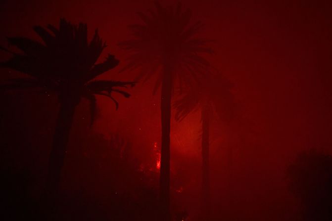 The wildfire burns through the canyons in Malibu on Tuesday.