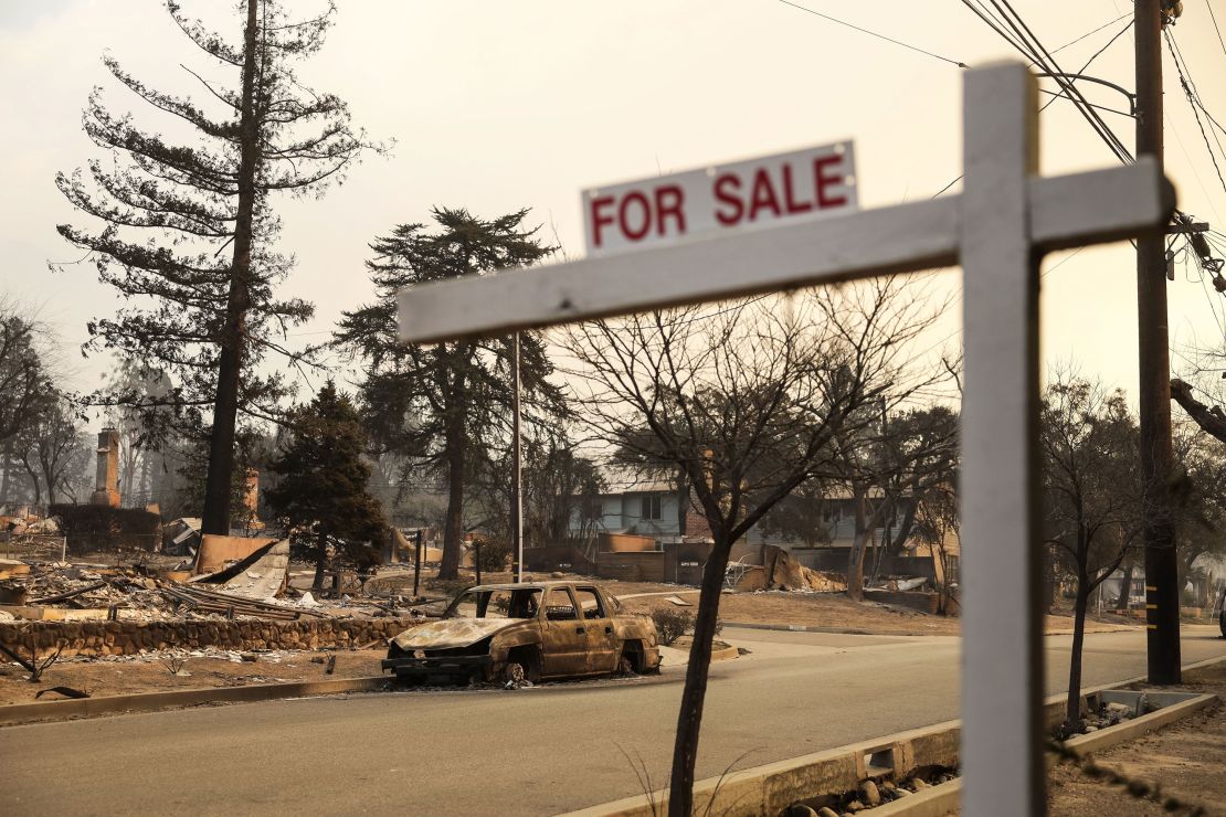 A "For Sale" sign sits in a neighborhood destroyed by the Eaton wildfire in Altadena, California.