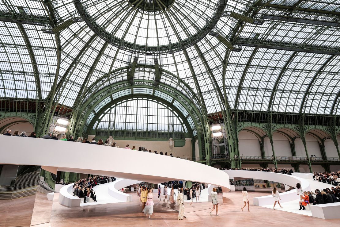 At Chanel's Spring/Summer 2025 Haute Couture show, models walked on a runway shaped like the brand's double-C logo.