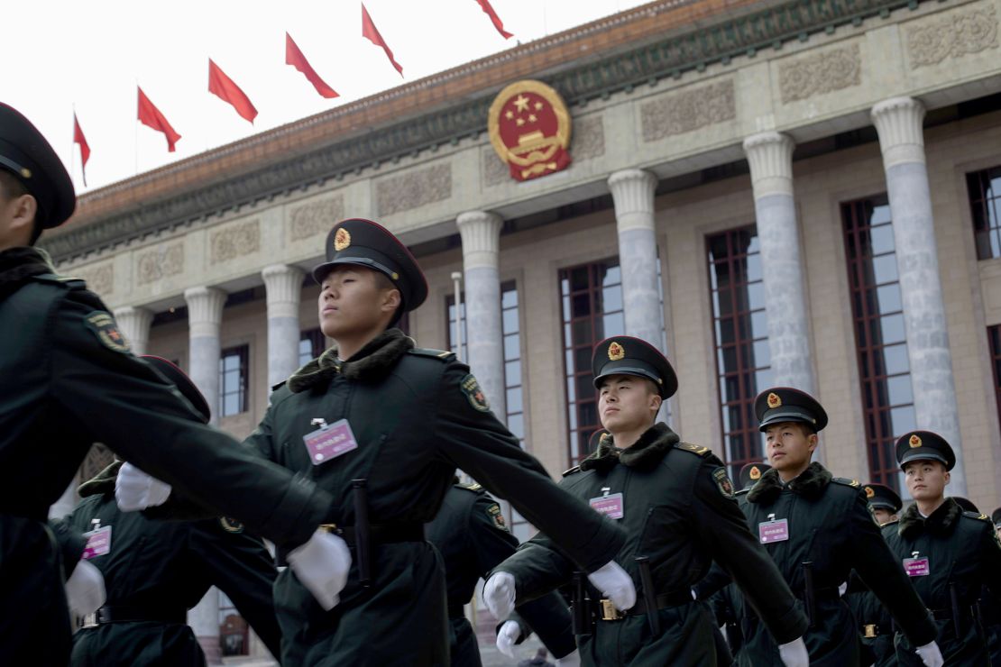 Chinese soldiers march outside Beijing's Great Hall of the People ahead of the start to this year's two sessions.