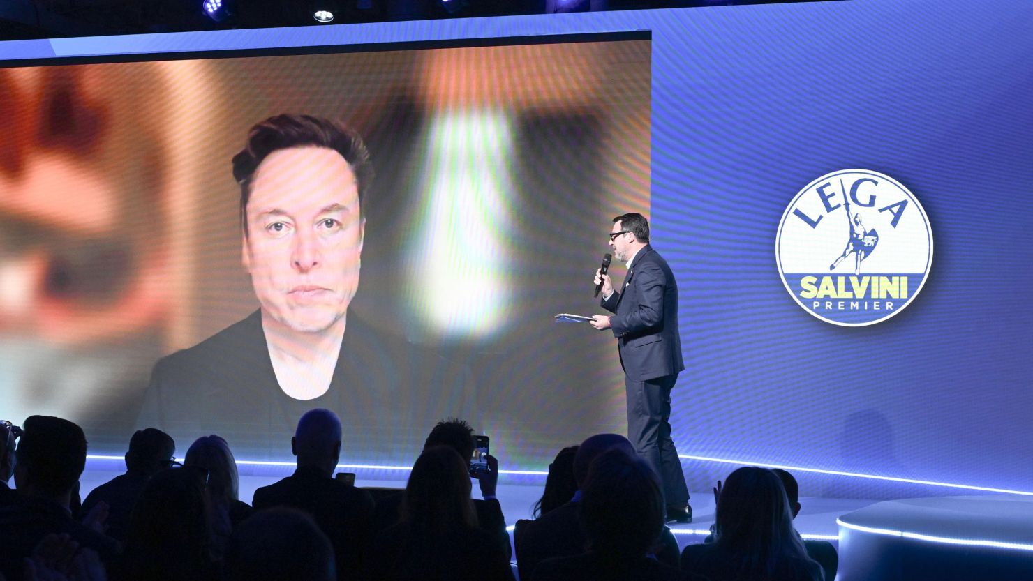 Elon Musk speaks via video link with Matteo Salvini, leader of the Lega per Salvini Premier party, during the Lega party federal congress in Florence, Italy, on April 5, 2025.