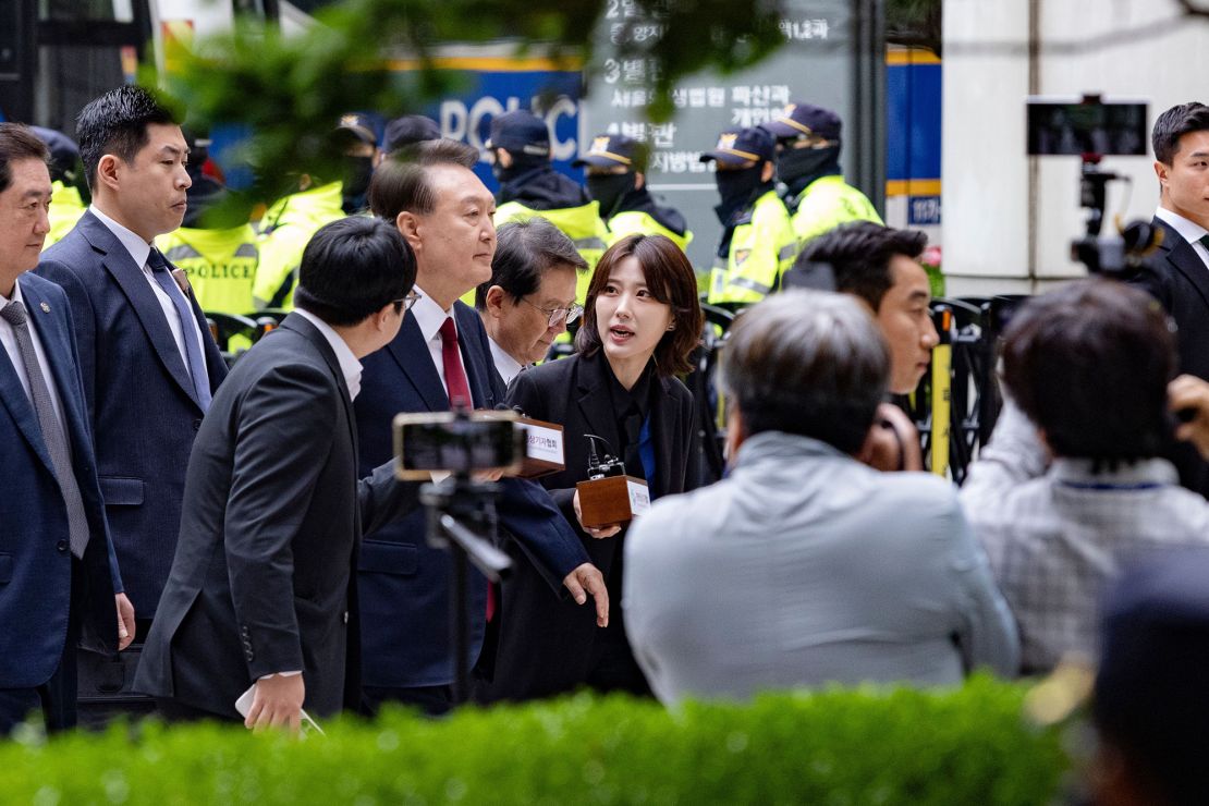 Former President Yoon Suk Yeol (center) arrives at the Seoul Central District Court for a criminal hearing in Seoul, South Korea, on May 19, 2025.