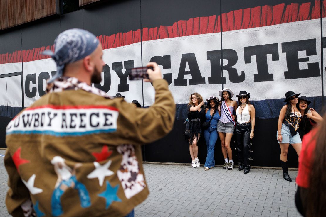 Concertgoers pose for a picture in London on June. 12.